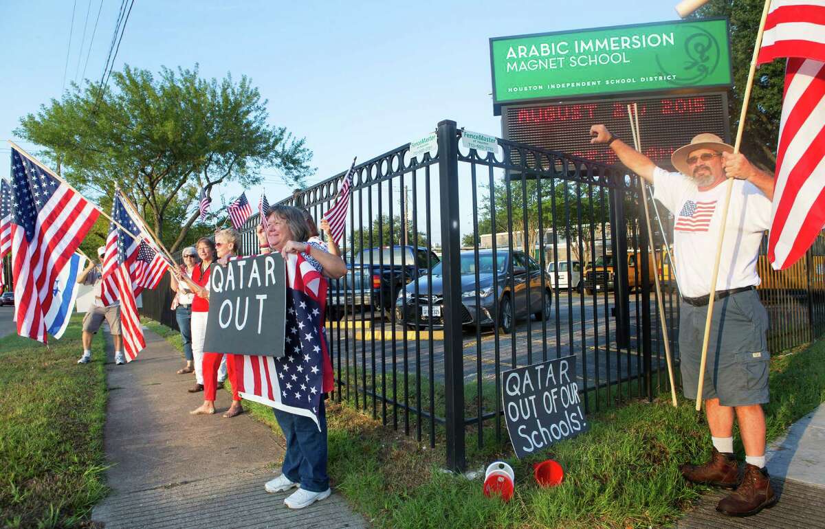 Protestors stand outside the Arabic Immersion Magnet School on Monday﻿.