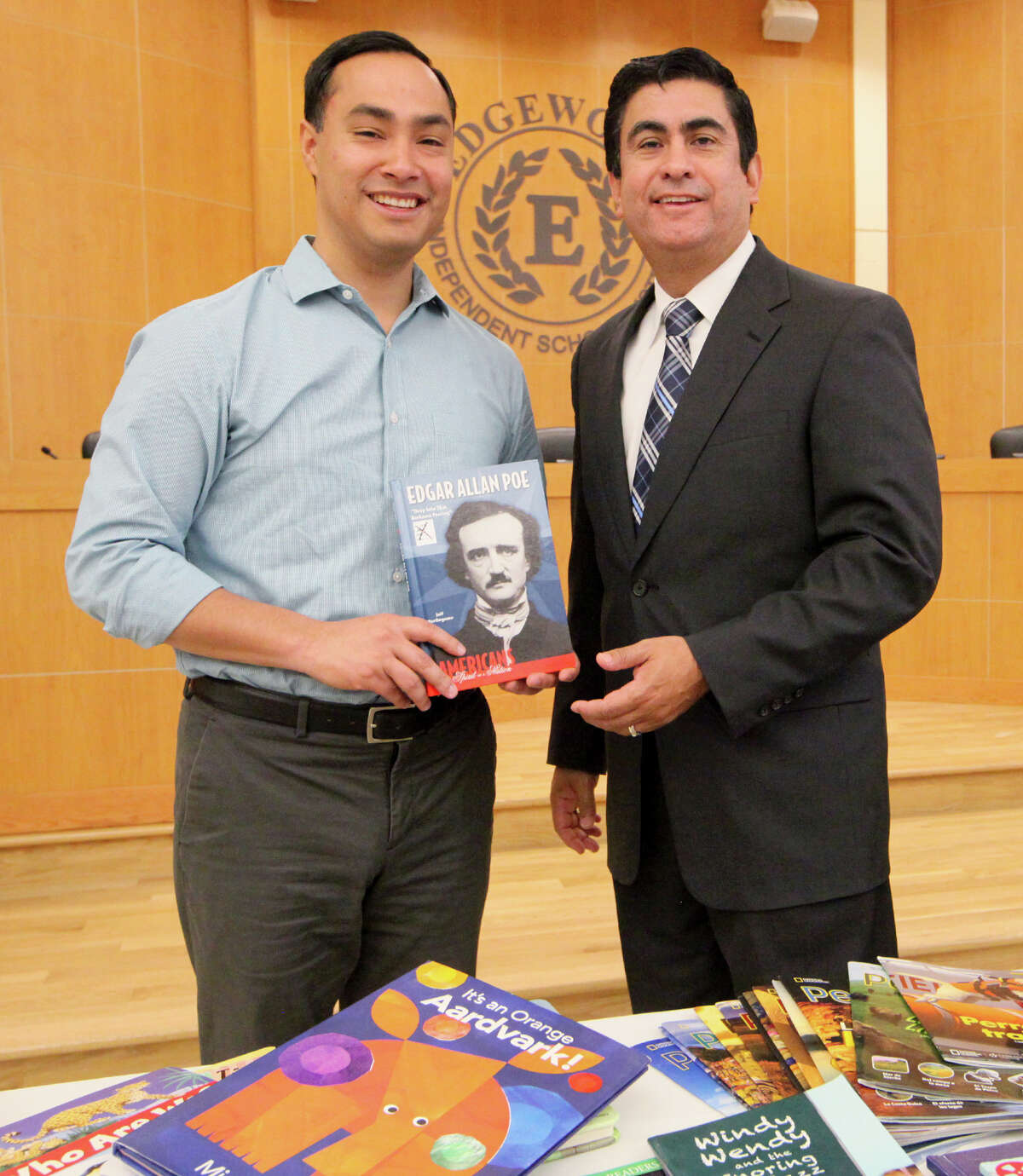 U.S. Rep. Joaquin Castro (left) delivers books donated from the Library of Congress to Edgewood ISD Superintendent Jose Cervantes at the Edgewood ISD Conference Center in the Guerra Center at 1930 Herbert Lane, on Friday, Dec. 19, 2014. The Library of Congress has a program for members of Congress to select surplus books from the Library's collection for donation to libraries in their district. The books are being distributed to the district's elementary and middle schools. MARVIN PFEIFFER/ mpfeiffer@express-news.net