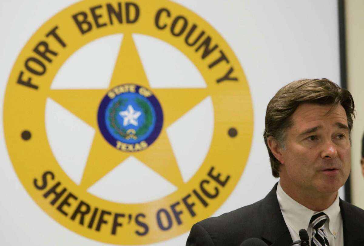 Fort Bend County District Attorney John Healey speaks during a news conference announcing the results of a large drug bust involving steroids Wednesday, May 27, 2009, in Rosenberg. Several suspects were taken into custody in what was dubbed the largest narcotics investigation in the history of Fort Bend County. The operation called "Farmacia de Juicy Phruit" involves the distribution of thousands of doses of anabolic steroids, human growth hormones, ecstasy an other drugs, law enforcement said in a statement Wednesday. Rodney Clarke, Special Agent-in-Charge, I.R.S. Houston Criminal Investigations, is shown on the right. ( Brett Coomer / Chronicle )