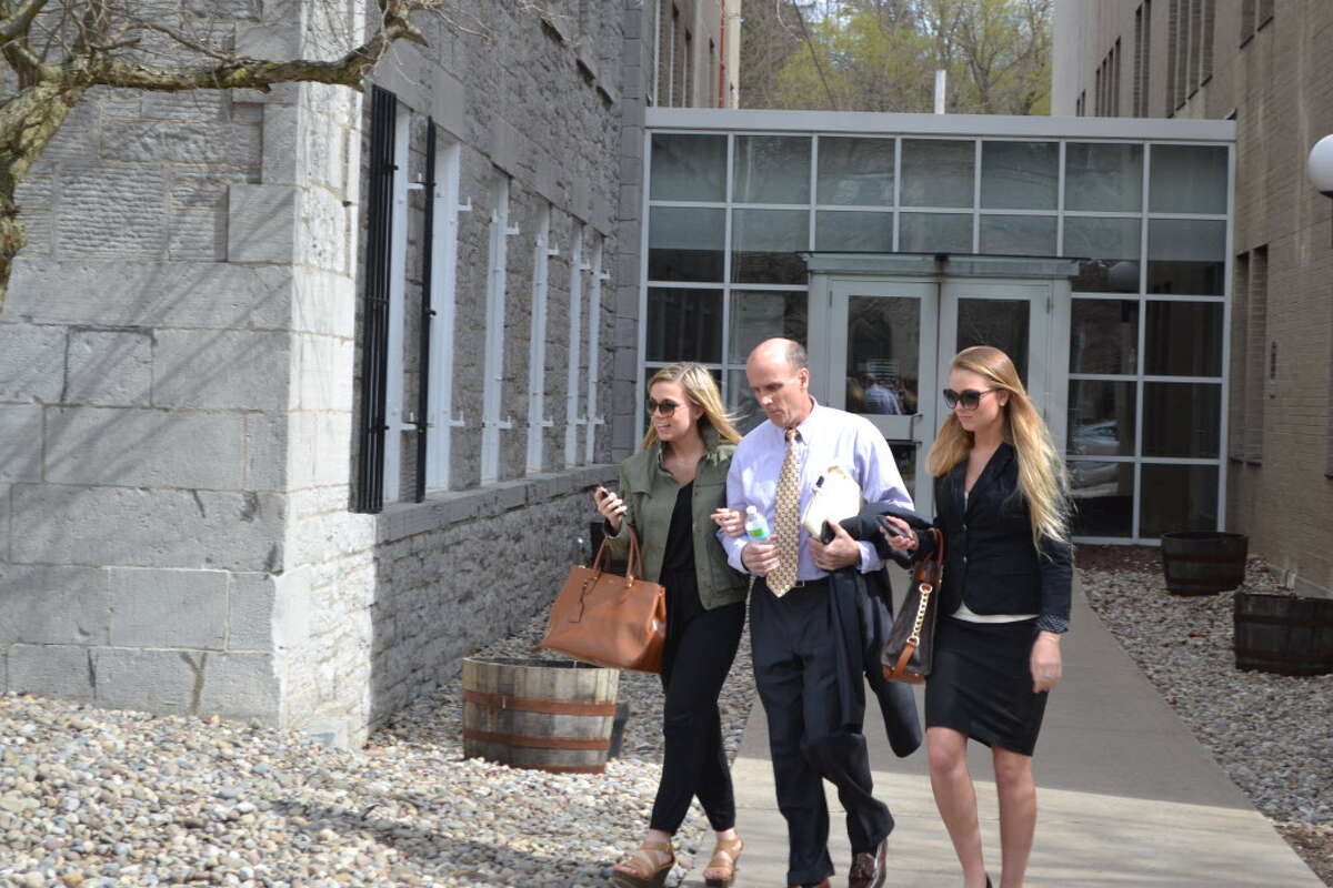 Cal Harris walks out of Schoharie County Court Tuesday, April 28, 2015, with his daughters Jenna and Cayla. The Tioga County man is accused of murdering his wife, Michele, on Sept. 11, 2001. Juries have twice convicted Harris of the murder, but both verdicts were reversed. (Keshia Clukey/ Times Union archive)
