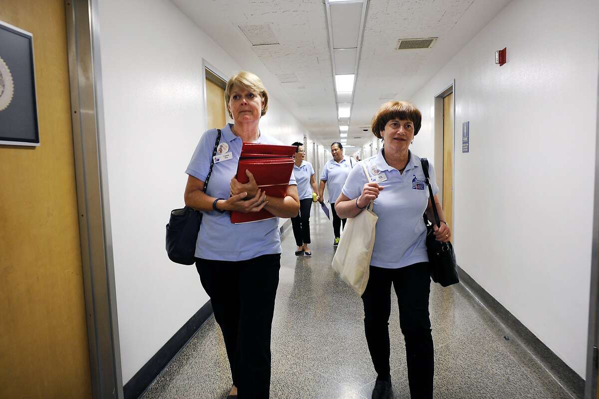 American Cancer Society Cancer Action Network staffer Cassie Ray, left, and volunteer Margo Connolly walk through the halls as they attempt to drop off petitions to select California State Assembly members at the State Capitol Building in Sacramento, CA Wednesday, August 26, 2015.