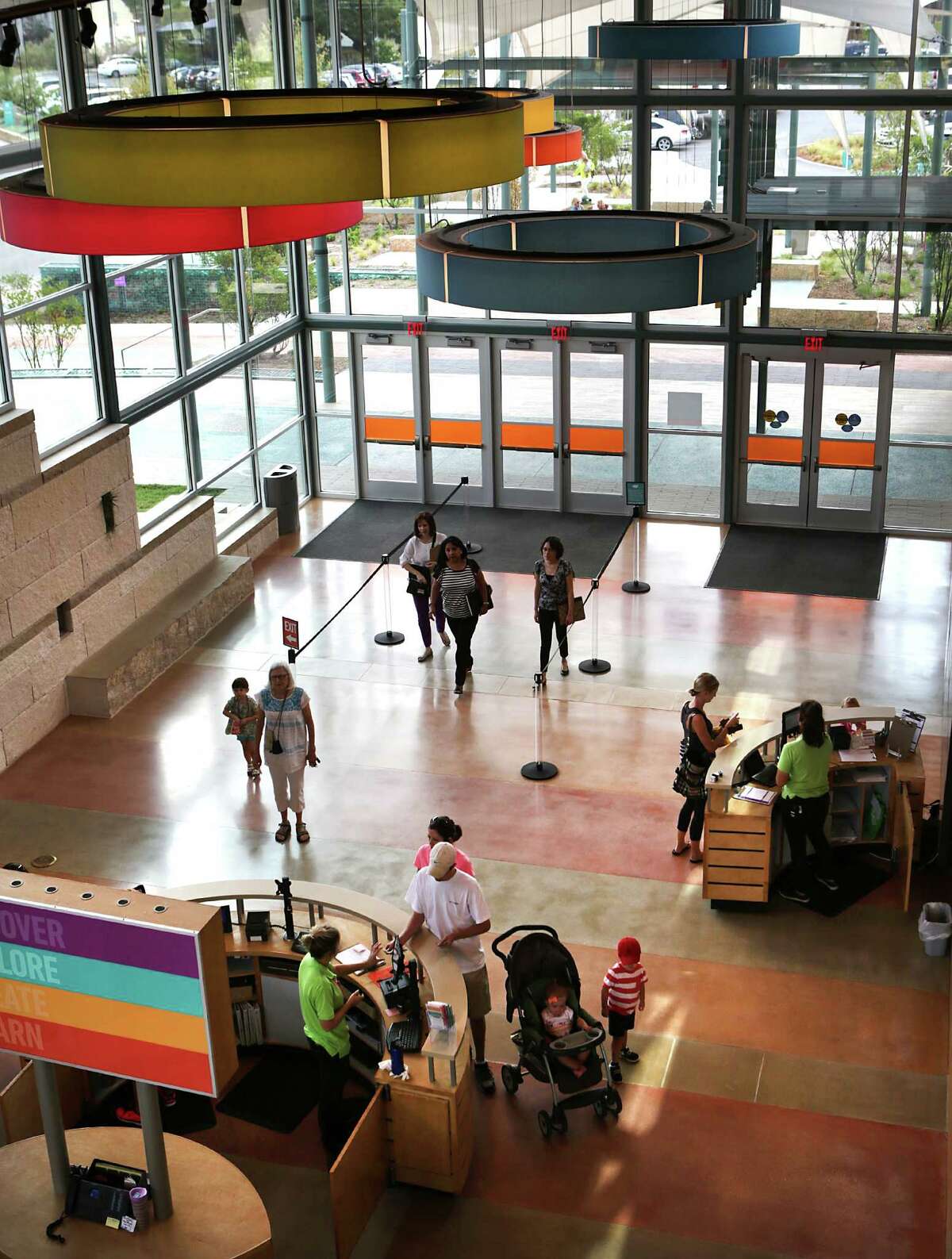 Visitors stream in the front entrance of The DoSeum on Wednesday, August 26, 2015. The DoSeum's 231 parking spaces are proving not to be enough and the popular kid and family location is trying to acquire 3 addresses on E. Mulberry Ave. to expand parking.