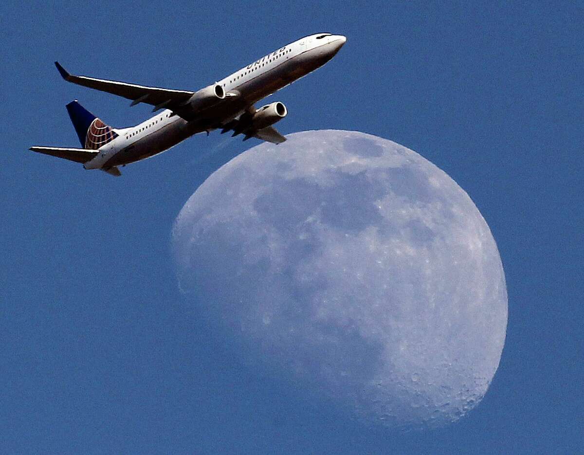 FILE - In this July 26, 2015, file photo, a United Airlines passenger airplane passes over Whittier, Calif., on its way to Los Angeles International Airport. Fliers in certain markets are seeing bargain flights as fare wars make a limited return. (AP Photo/Nick Ut, File)