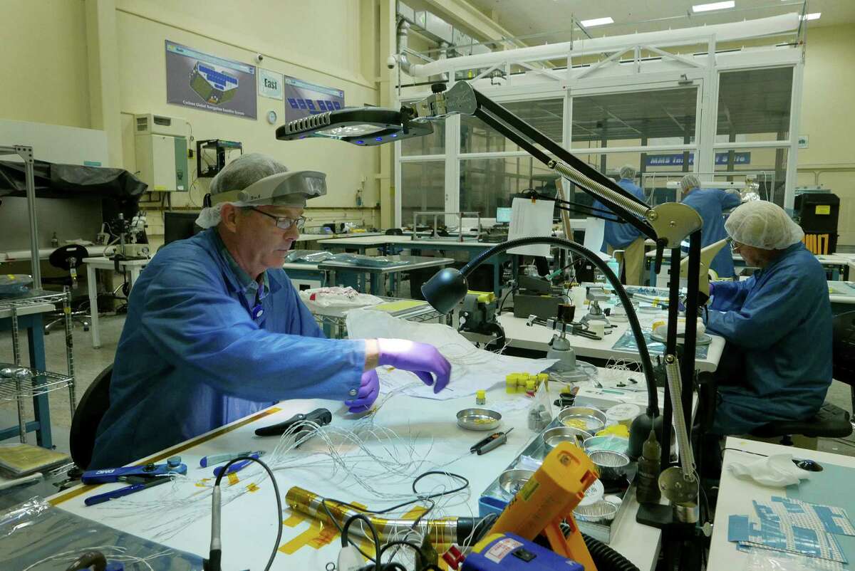 James Foster helps assemble components for CYGNSS satellites in a lab at Southwest Research Institute in San Antonio on Tuesday, Aug. 25, 2015. The system will use eight separate satellites to measure from space surface wind speed in hurricanes.