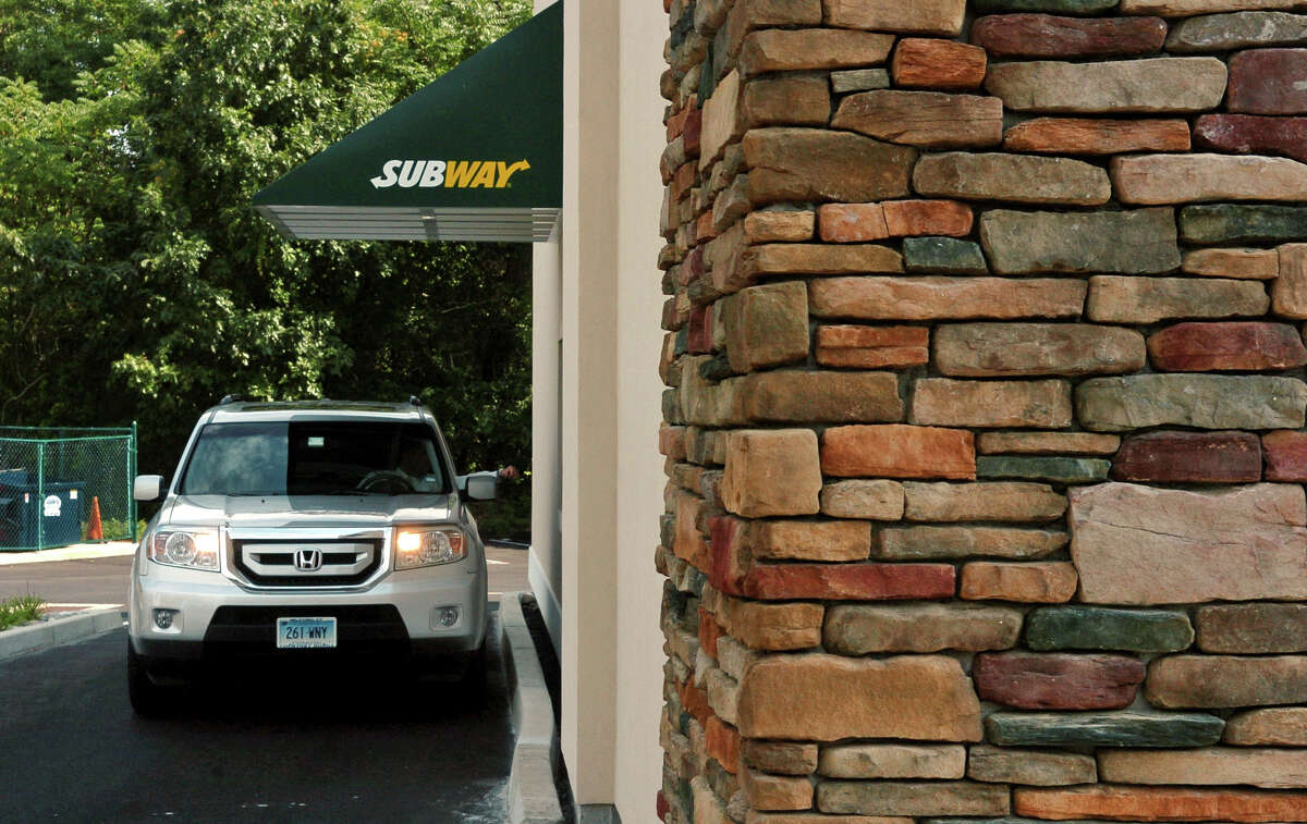 A car goes through the drive thru at the Subway along Post Road in Orange.