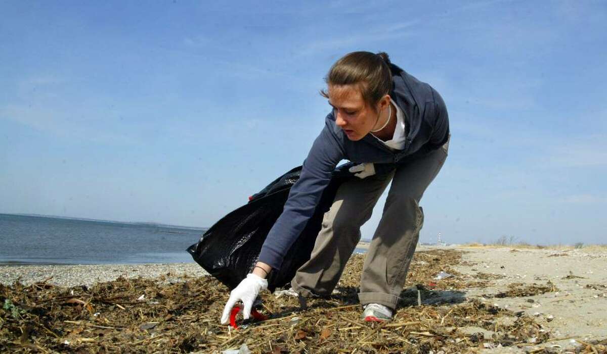 Melissa Chingo, of Hamden, picks up trash along Long Beach in Stratford, Sunday, March 21, 2010. Chingo was taking part in the 2010 Beach Week Clean Up sponsored by Connecticut Community Boating.