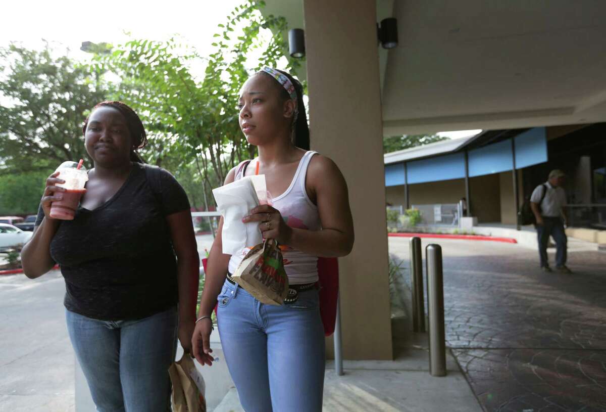 Latanya Rozier, right, and Ranesha Ferguson, stand outside the Wyndam - Houston Medical Center Hotel, where they are staying until Texas Southern University completes a dorm, Thursday, Aug. 27, 2015, in Houston. Rozier, who moved from Chicago, didn't find out about her living situation until she arrived in Houston.