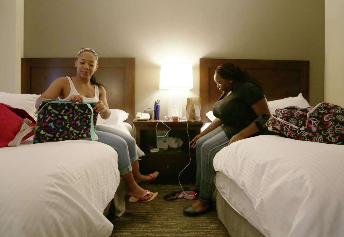 Latanya Rozier and Ranesha Ferguson unpack at the Wyndam - Houston Medical Center Hotel, where they, and about 100 TSU students, are staying. ﻿