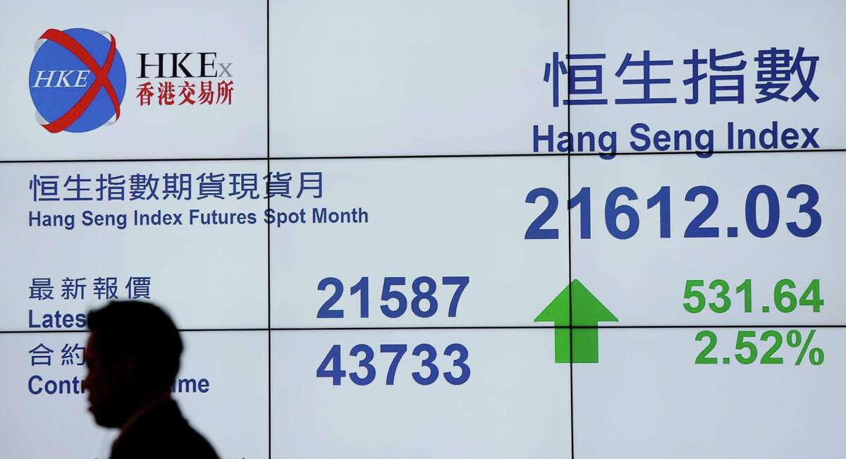 A passer-by is silhouetted in front of a bank's electronic board showing the Hong Kong share index at Hong Kong Stock Exchange in Hong Kong Thursday, Aug. 27, 2015. China's main stock market index has surged 5.3 percent, its biggest gain in eight weeks, as Asian markets rose following Wall Street's overnight rebound. (AP Photo/Vincent Yu)