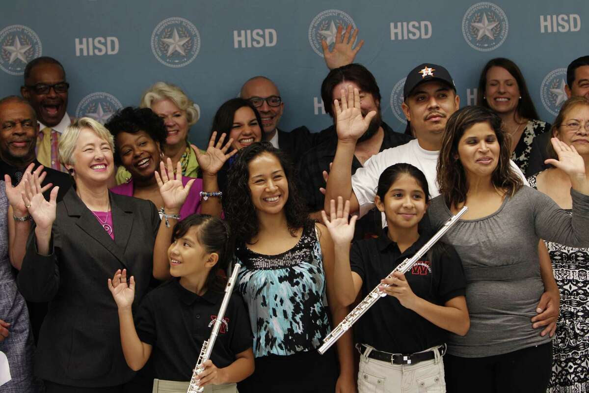 After a press conference announcing partnership between Washington's Kennedy Center, HISD and City of Houston in national arts education program Thursday, Aug. 27, 2015, in Houston. Participants in event gathered for a group photo and waved to the camera. Houston is 19th city selected to join the program. Participants in event ( Steve Gonzales / Houston Chronicle )