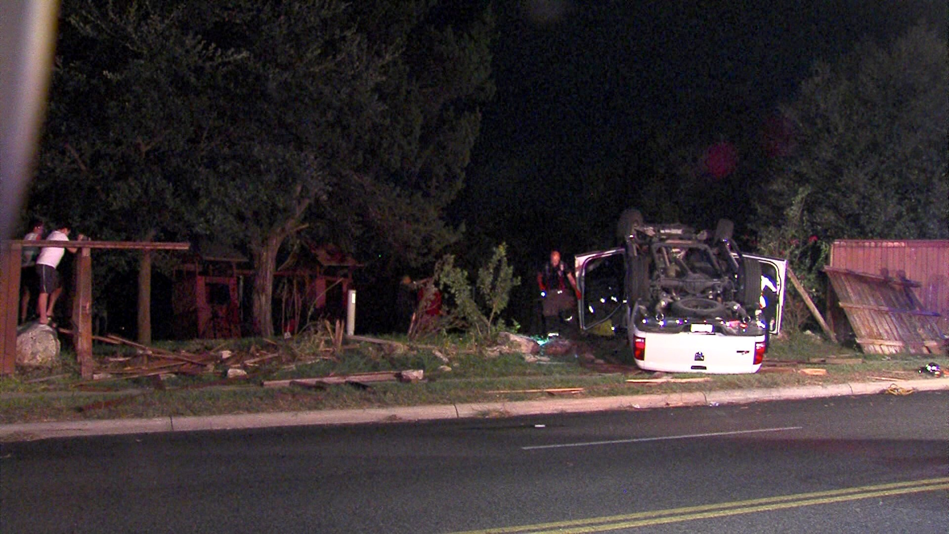 Truck rolls over, crashes into fence on Northwest Side