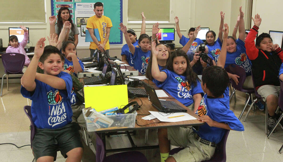 The Texas Supreme Court will hear arguments in yet another legal challenge to how the state finances its public schools. At the moment, low-income school districts suffer. These children at Graebner Elementary school raise their hands while former San Antonio Spur Bruce Bowen asks a question in Octtober 2014.