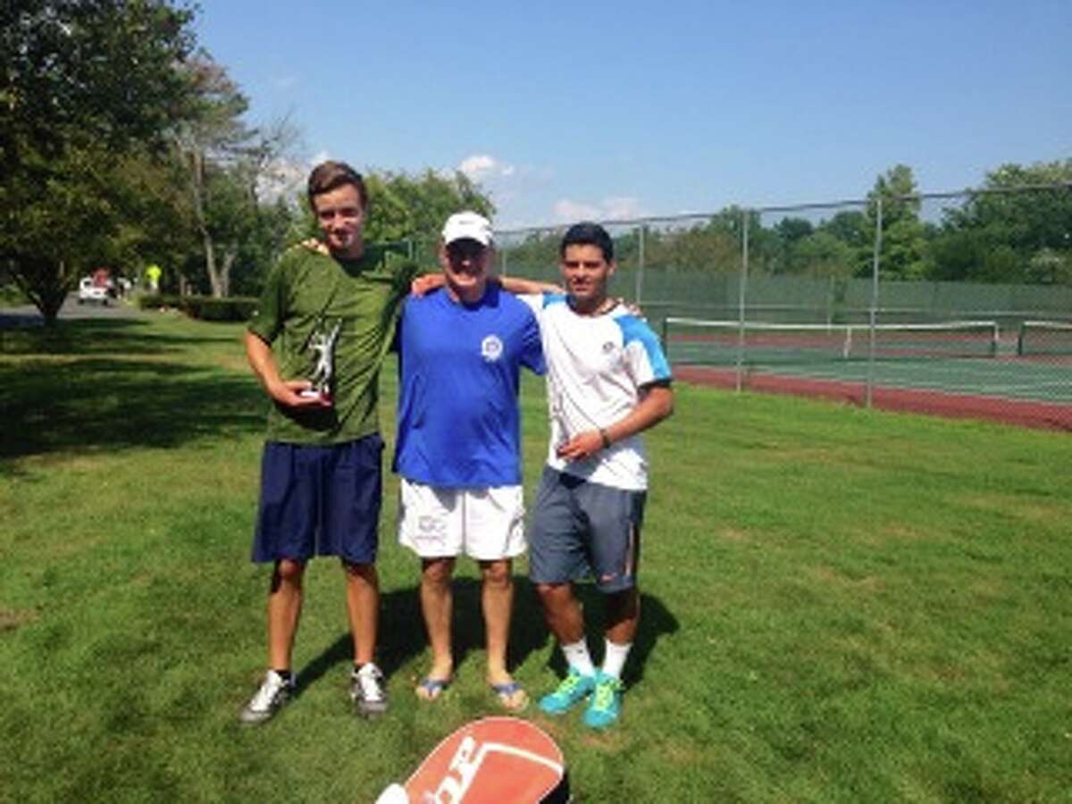 Henry DeCoster, left, won the Greenwich Town Tennis Tournament’s 17-and-under singles championship Tuesday at Binney Park in Greenwich. Also pictured are tournament director Pat Cianciulli, center, and Alessio Fikre, who played DeCoster in the final.