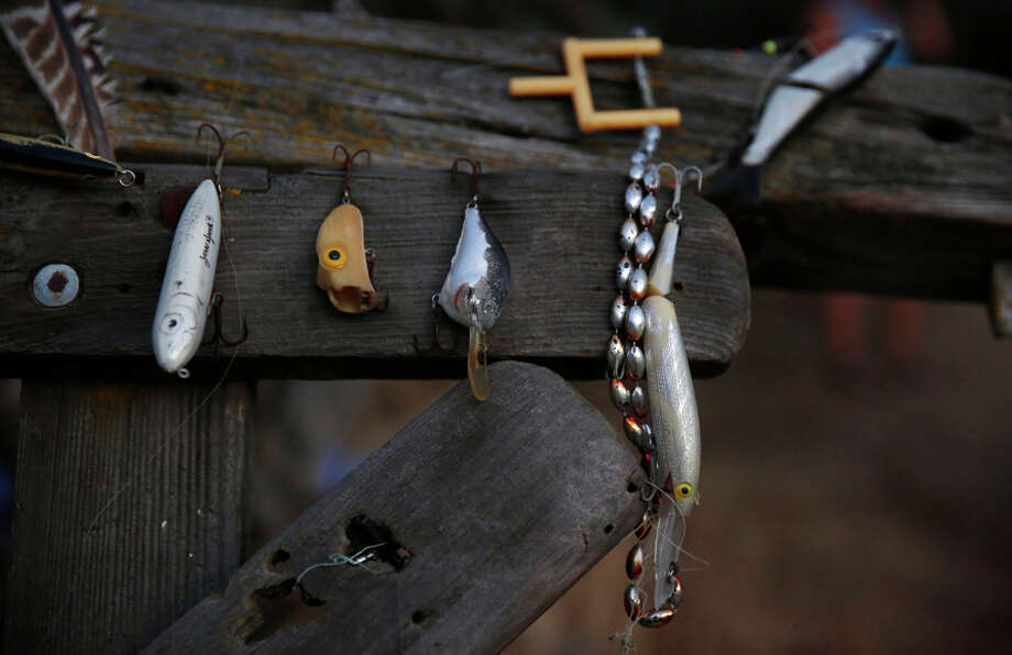A collection of fishing hooks that Anita Lodge’s family has found over the years hangs on display near her property. / ONLINE_YES