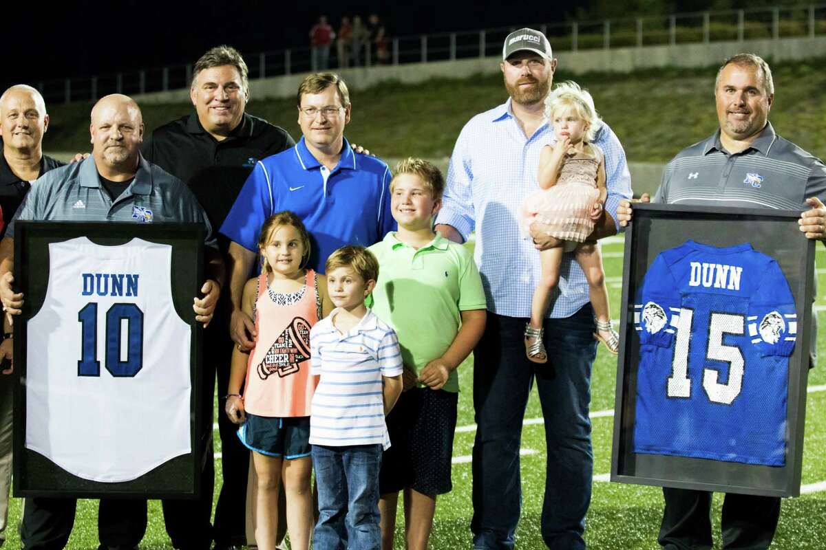 New Caney held a ceremony to retire former baseball slugger Adam Dunn's football and baseball jerseys. Dunn, second from right, played 14 MLB seasons.