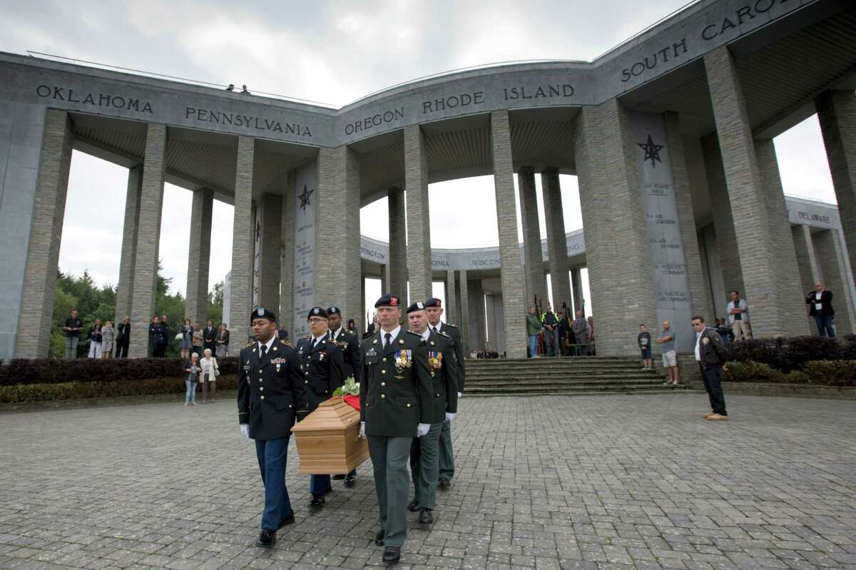 Soldiers of the U.S. and Belgian Army carry the coffin of Augusta Chiwy during a memorial service at the Mardasson Memorial in Bastogne, Belgium on Saturday, Aug. 29, 2015. Augusta Chiwy, 94, a Belgian nurse who helped save hundreds of American soldiers during the Battle of the Bulge at the end of World War II, was buried Saturday near where thousands of Allied troops fell. (AP Photo/Virginia Mayo)