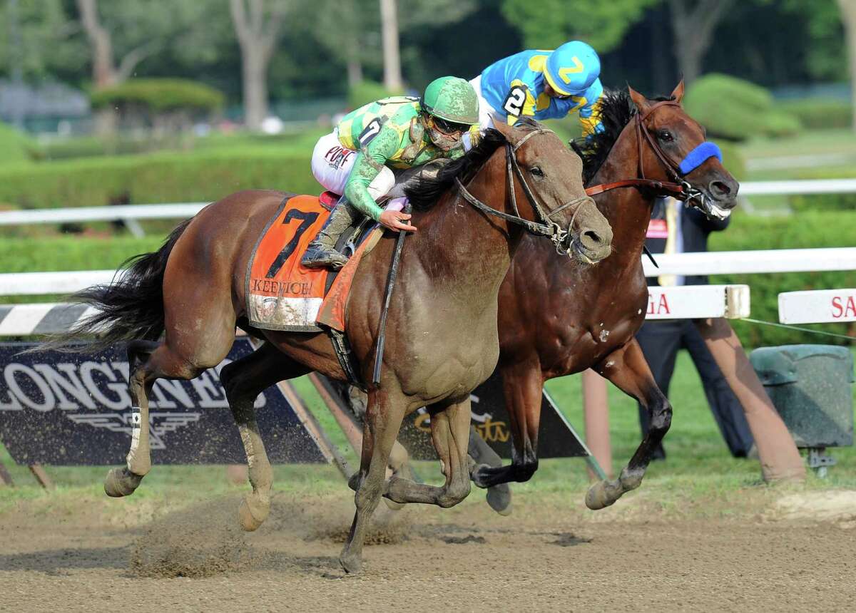 Keen Ice (7), with Javier Castellano, moves past Triple Crown winner American Pharoah, with Victor Espinoza, to win the Travers Stakes on Saturday at Saratoga Race Course in Saratoga Springs, N.Y.﻿
