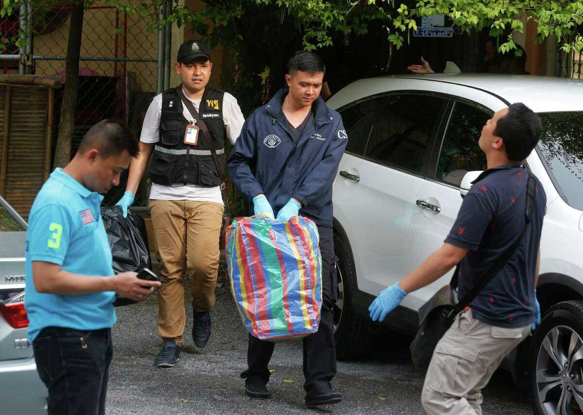 Thai policemen take evidence at an apartment on the outskirts of Bangkok, Thailand on Saturday, Aug. 29, 2015. Thai authorities raided an apartment in suburban Bangkok and arrested a foreigner with a fake Turkish passport and bomb-making materials Saturday, the first possible breakthrough in the deadly bombing at a Bangkok shrine nearly two weeks ago.(AP Photo/Sakchi Lalit)