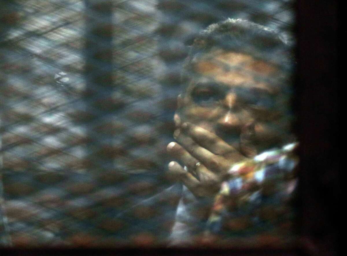 Canadian Al-Jazeera journalist Mohammed Fahmy listens to his verdict from a soundproof glass cage Saturday inside Tora prison in Cairo, Egypt.