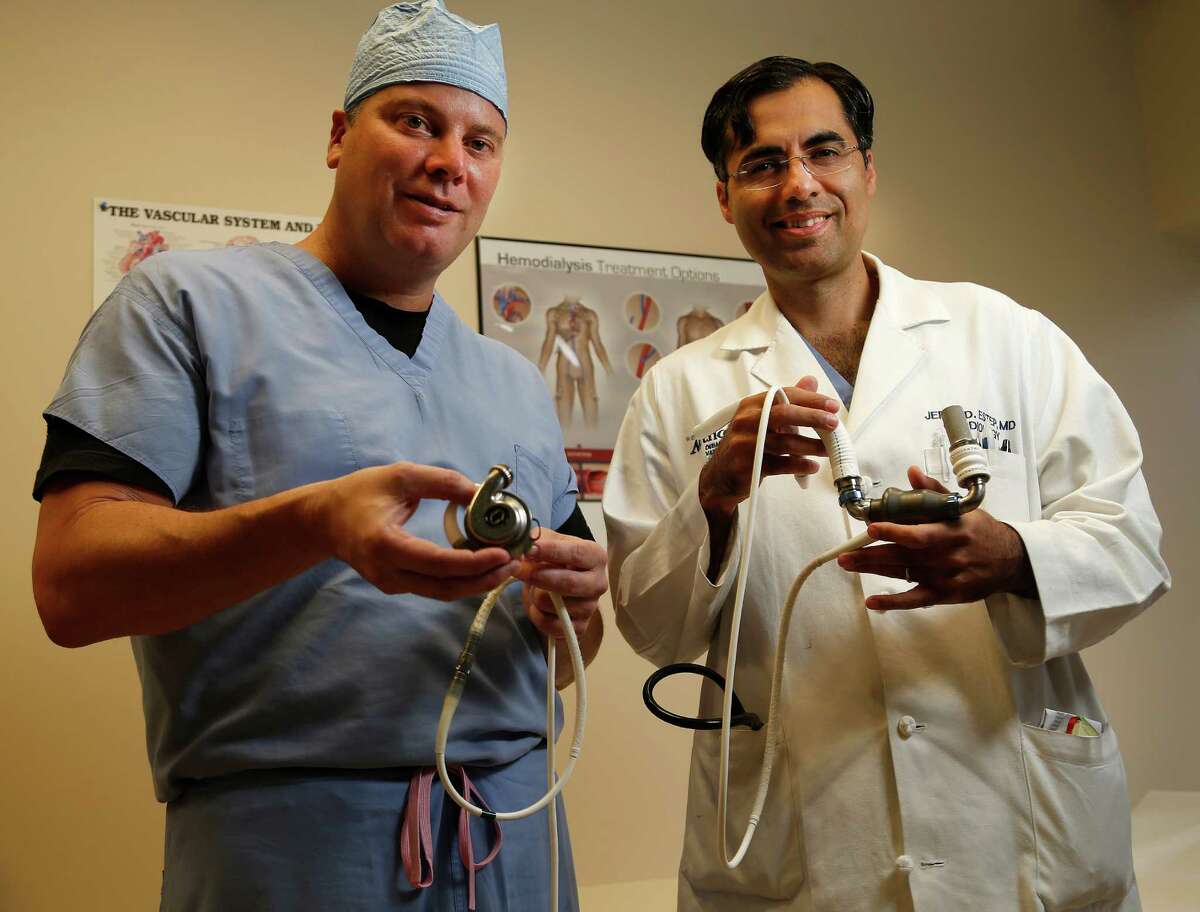 Dr. Brian Bruckner, left, a heart transplant surgeon, and Dr. Jerry Estep, cardiologist, display two versions of the left ventricular assist devices at Houston Methodist Hospital. "These patients have meaningful improvements in quality of life," Estep says.