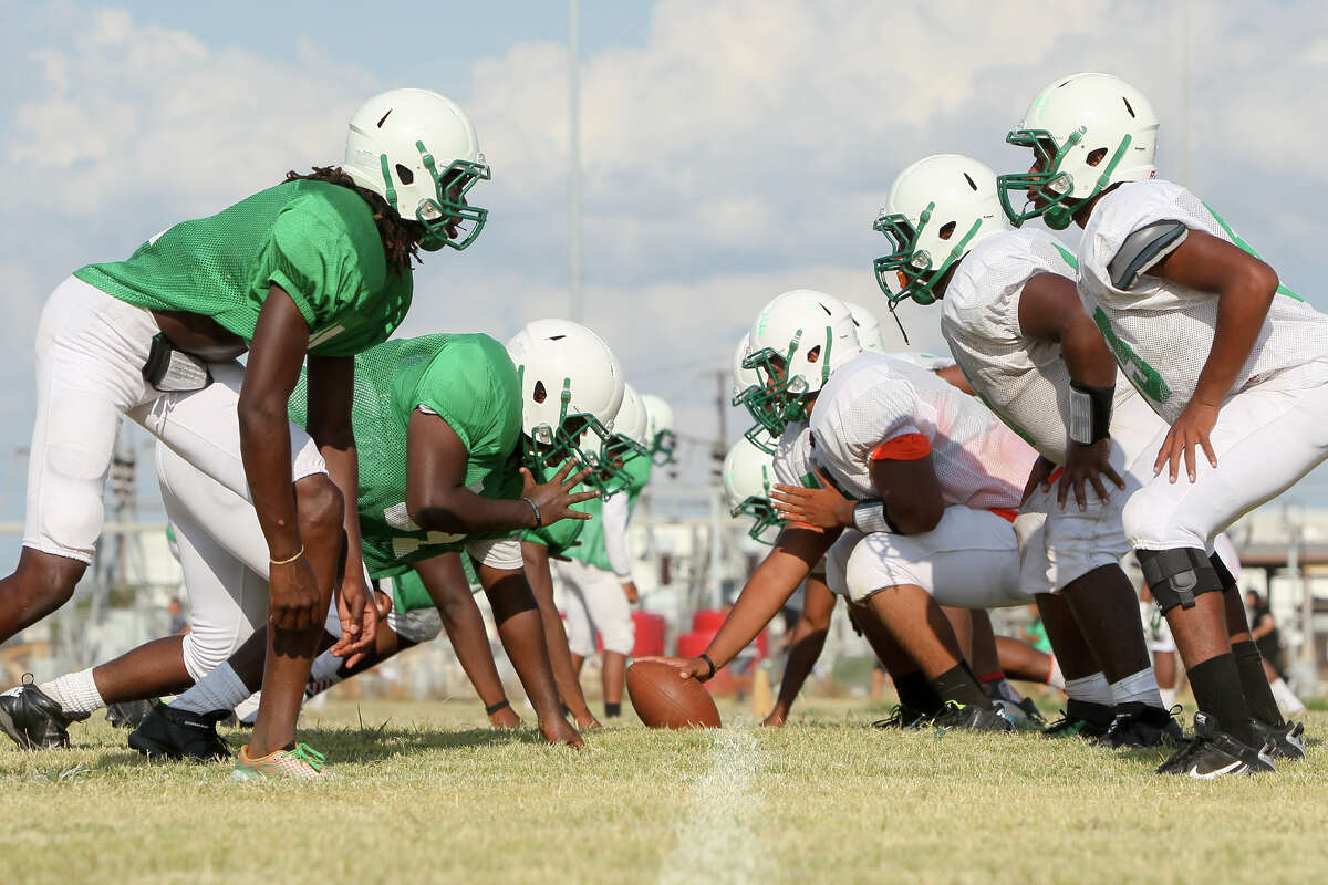The Sam Houston Hurricanes prepare to run a play during a practice session at the school on Tuesday, August 18, 2015. MARVIN PFEIFFER/ mpfeiffer@express-news.net