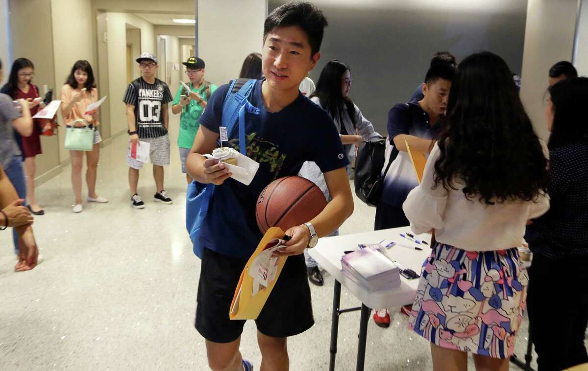 ﻿Weikang Nie, a finance graduate student from China, walks into an orientation for Chinese students at the University of Texas at Dallas in Richardson﻿. The U.S. Census Bureau research shows immigrants from China and India, many with student or work visas, have overtaken Mexicans as the largest groups coming into the United States.﻿
