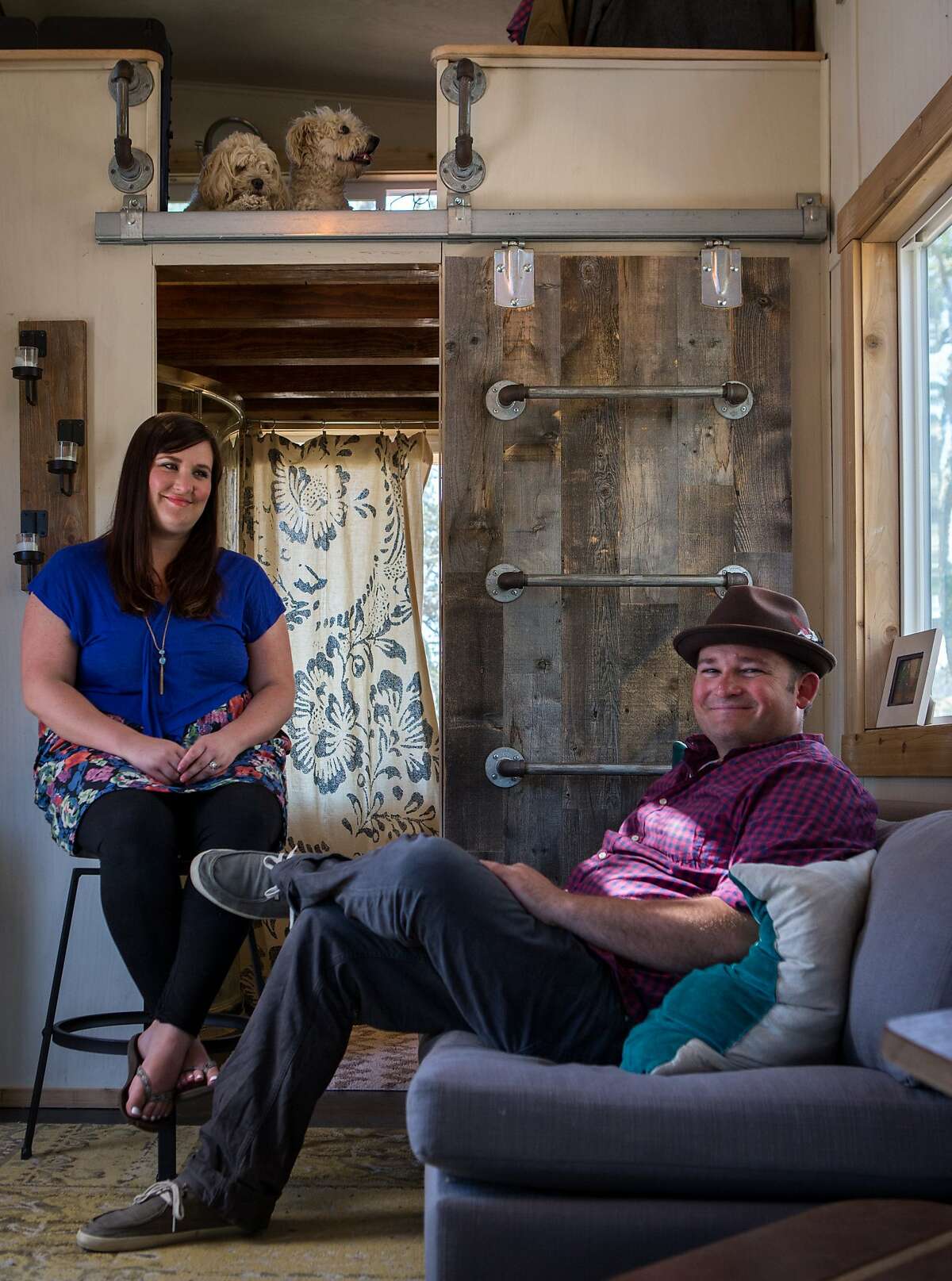 Shelley and Joshua Engberg relax in the sitting area of their tiny home in the East Bay hills. 
