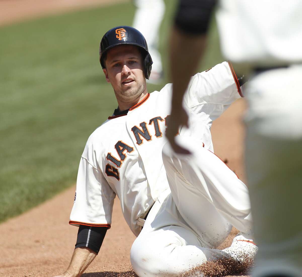 San Francisco Giants' Buster Posey scores against the St. Louis Cardinals during the first inning of a baseball game, Sunday, Aug. 30, 2015, in San Francisco. (AP Photo/George Nikitin)