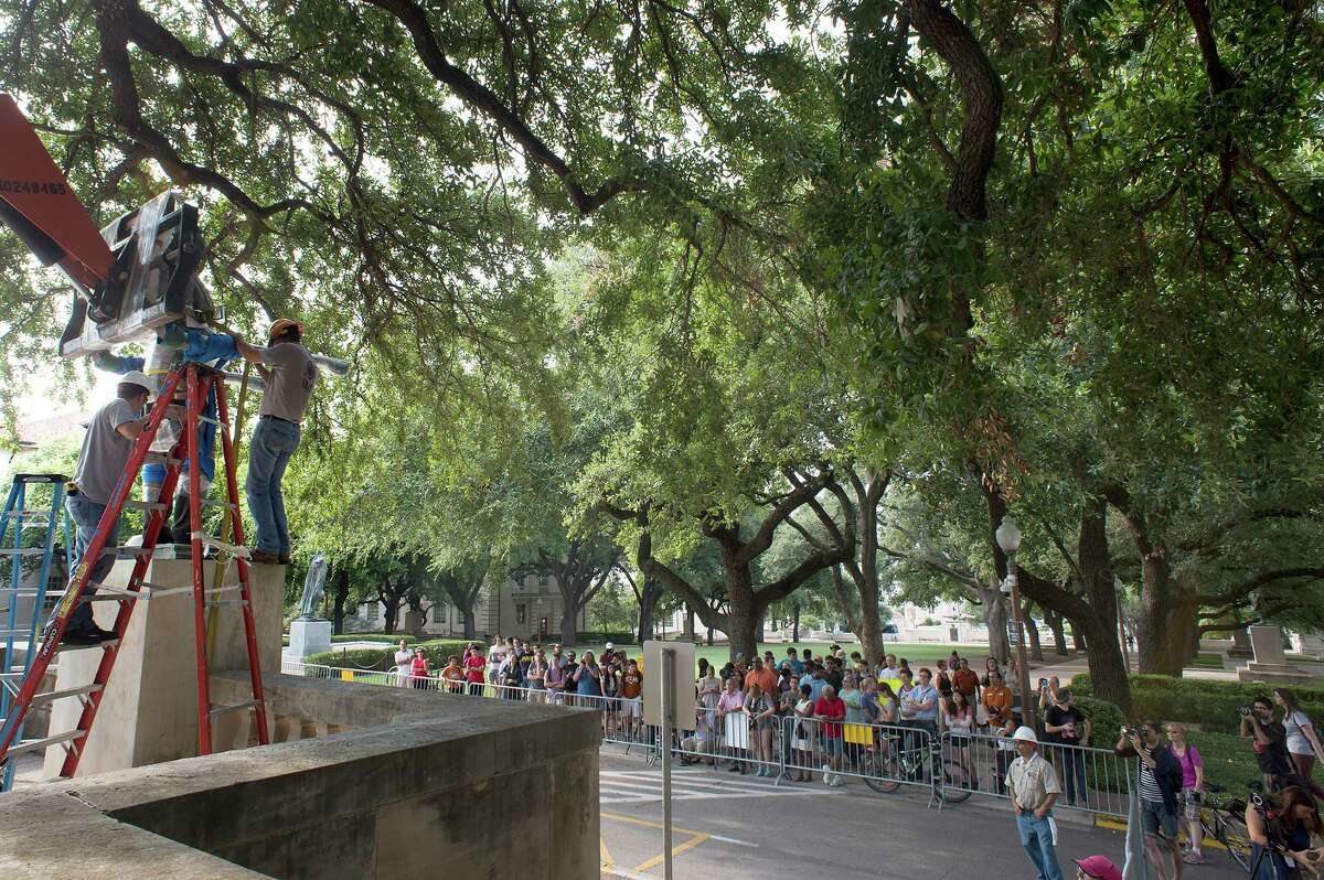 A crowd gathered near the Main Mall Steps on the Campus of the University of Texas Austin to watch the removal of the Jefferson Davis statue Sunday Aug. 30, 2015. Both the Davis and Woodrow Wilson Statues were removed from the Main Mall steps of University of Texas Austin in front of the UT Tower.