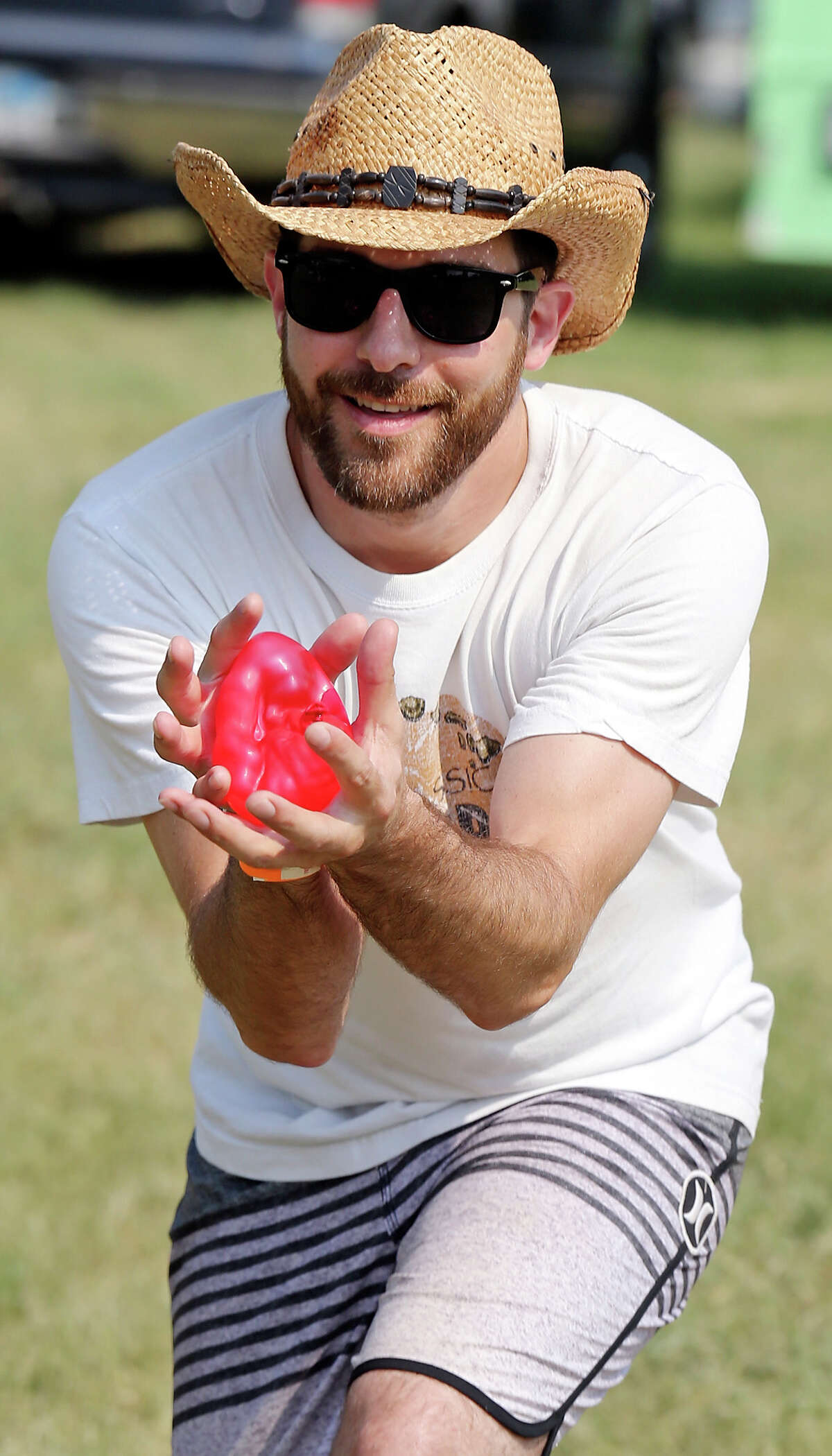 Jeremy Hebert competes in a water ballon toss at the Float Fest. ,