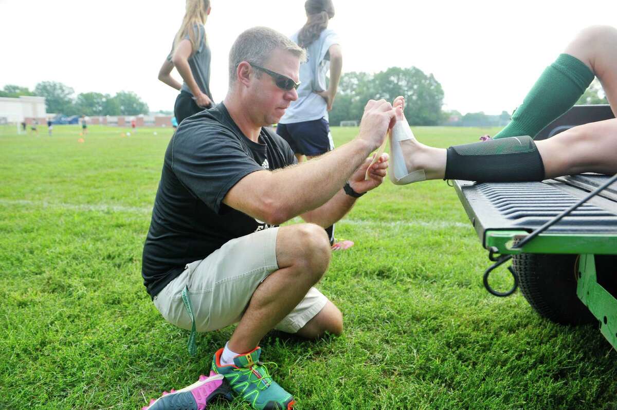 Rick Knizek, athletic trainer at Shenendehowa High School works with girl soccer players at practice on Wednesday, Aug. 19, 2015, in Clifton Park, N.Y. (Paul Buckowski / Times Union)