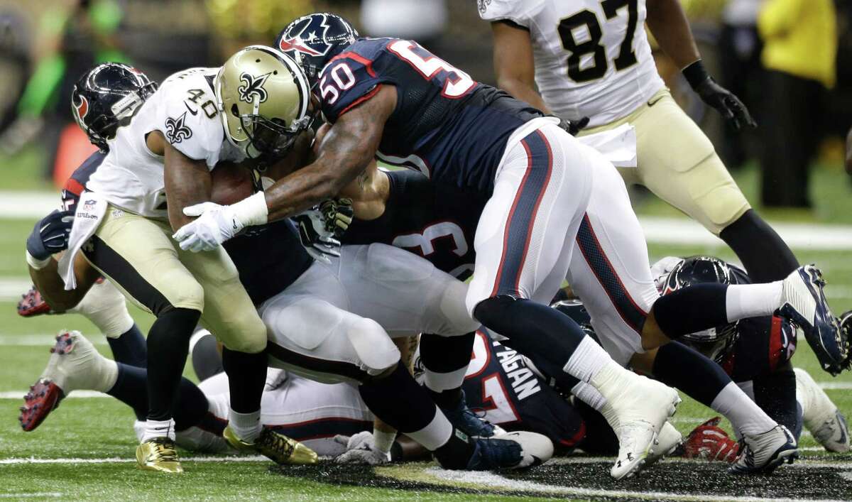 Saints running back Marcus Murphy (48) is stopped by Texans inside linebacker Akeem Dent (50) during the second quarter﻿.