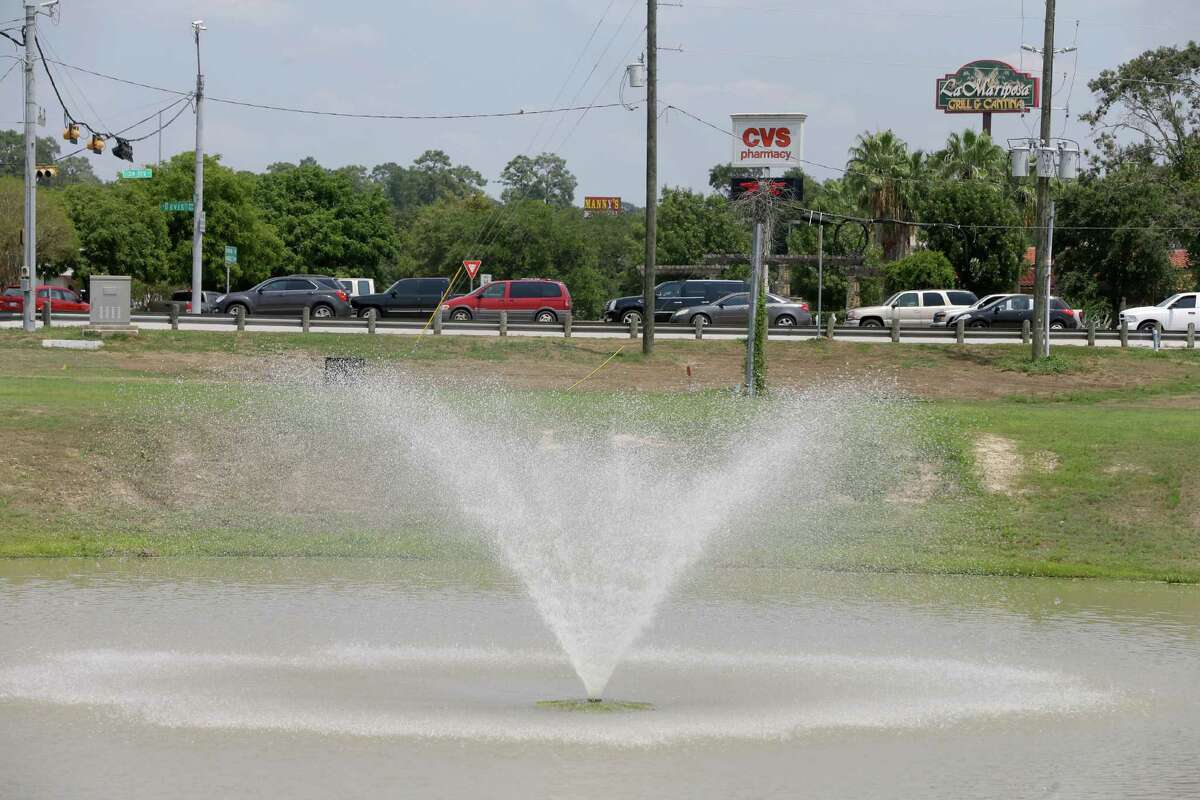 One of two ponds with fountains along West Davis Street near I-45 is shown Friday, Aug. 28, 2015, in Conroe. There are no sidewalks along West Davis Street from the ponds to downtown or the fast-food outlets and pharmacies in between.