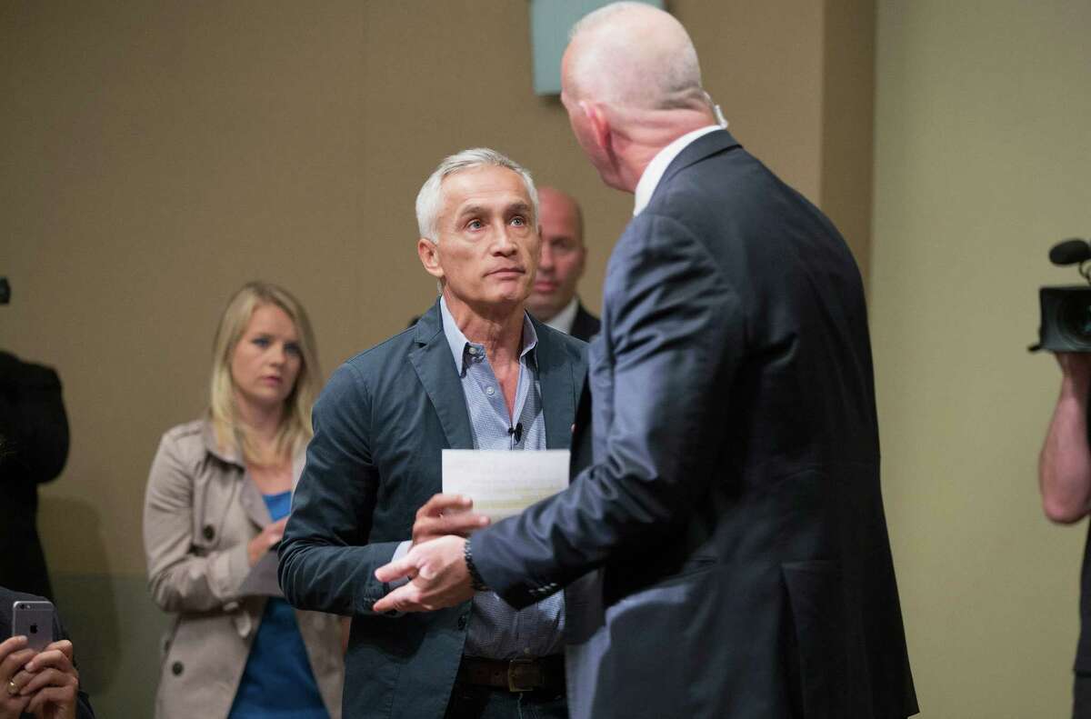 A security staff member for Republican presidential candidate Donald Trump removes Univision and Fusion anchor Jorge Ramos from a press conference after a heated exchange between the journalist and the politician.
