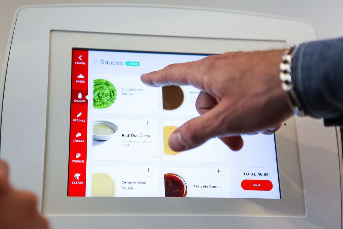 Andrew Lieberman orders his food on a machine at the grand opening of Eatsa, a new fully automated fast food restaurant in Rincon Center in San Francisco, California, on Monday, Aug. 31, 2015.