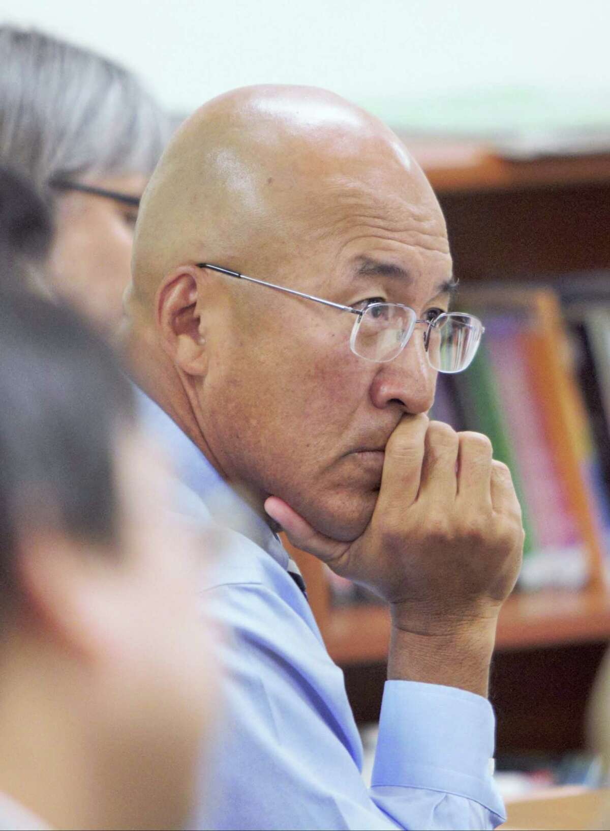 Former Greenwich High School band director John Yoon listens to testimony at a public hearing, regarding his dismissal for abusive behavior, at the Greenwich School's Board of Education in Greenwich, Conn. on August 31, 2015.