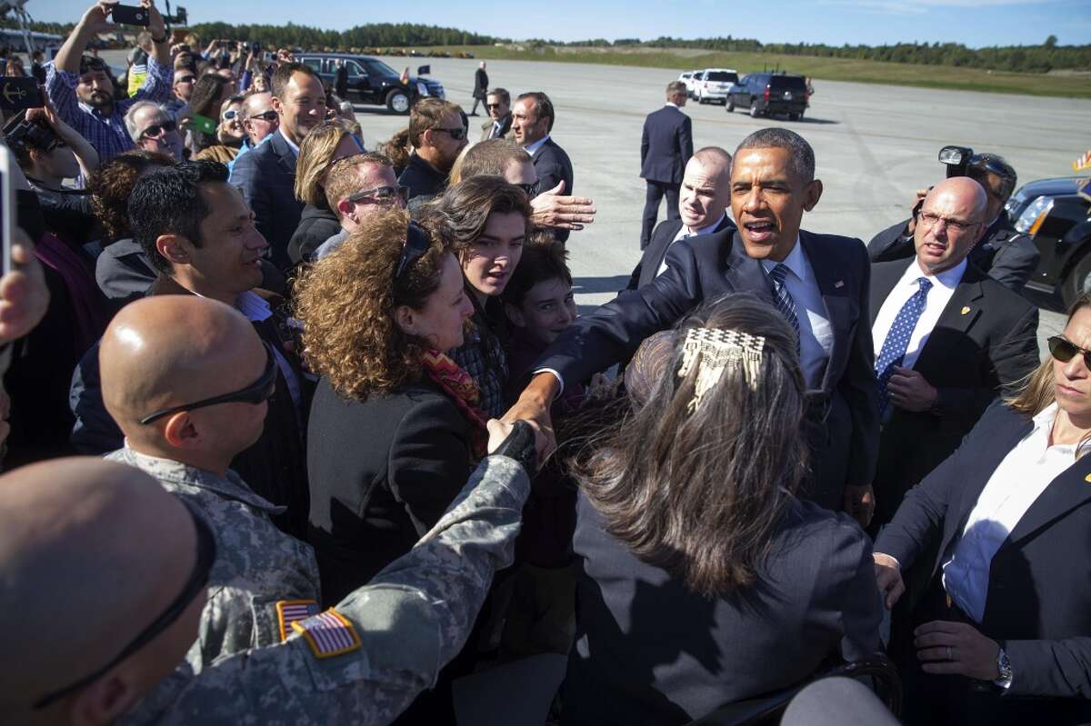 President Barack Obama greets supporters as he arrives at Elmendorf Air Force Base in Anchorage, Alaska, Aug, 31, 2015. Obama traveled to Alaska on the first presidential visit above the Arctic Circle to call for aggressive action to tackle climate change and to participate in a roundtable with Alaska Natives. (Doug Mills/The New York Times)