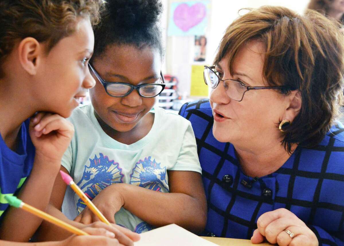 Newly appointed State Education Commissioner Maryellen Elia, right, with first graders Miguel Falu-Garcia, left, and Lashon Fraser during a visit a Pine Hills Elementary School Wednesday, May 27, 2015, in Albany, N.Y. (John Carl D'Annibale / Times Union)