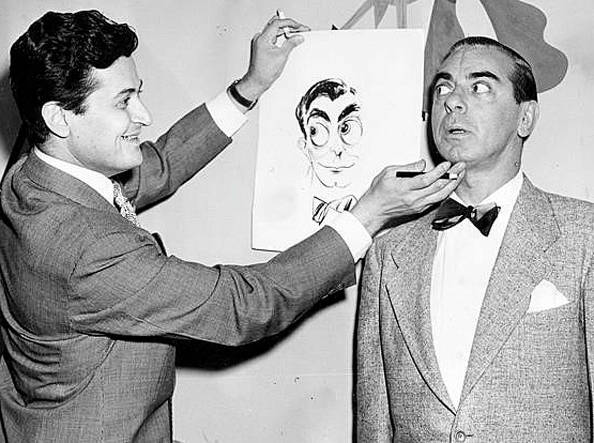 Harry Neigher, left, longtime columnist and cartoonist for the former Bridgeport Herald, sketches entertainer Eddie Cantor. Works by Neigher and colleague Frank Gerratana, the Herald's chief photographer, are showcased in a new exhibit at the Fairfield Museum and History Center.