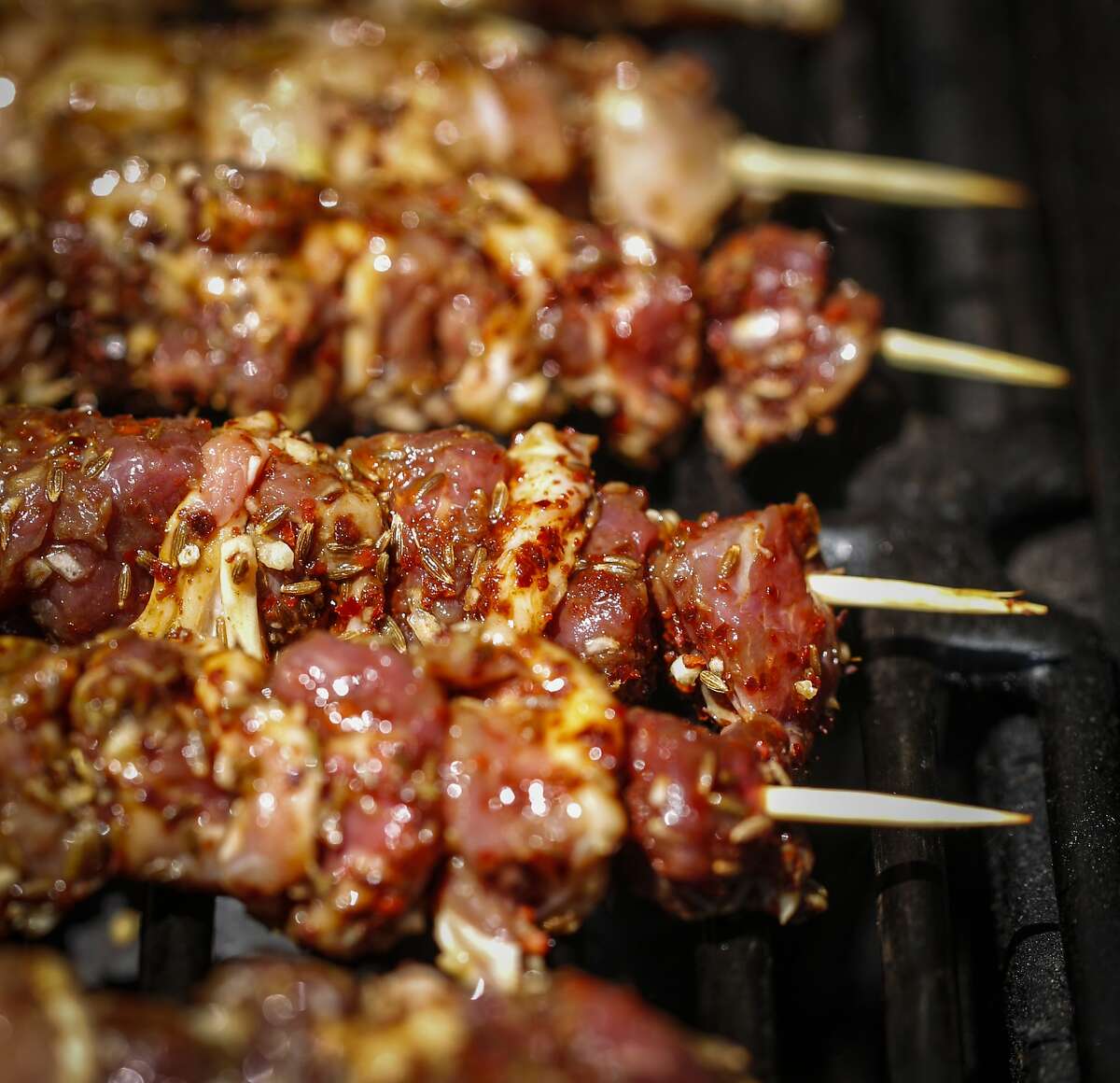Chicken and lamb skewers dusted with chiles, cumin and garlic are seen on Thursday, Aug. 27, 2015 in San Francisco, Calif.