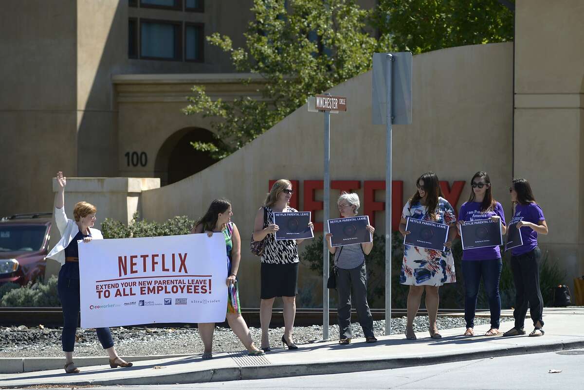 A broad coalition of activists gather in front of Netflix to protest the company's parental leave program in Los Gatos, Calif., on Tuesday, Sept. 1, 2015.