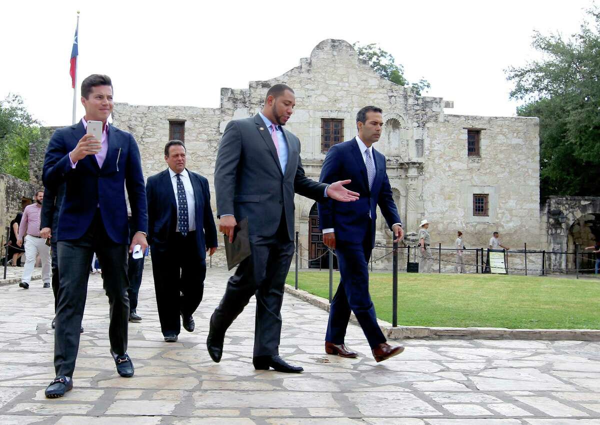 Texas Land Commissioner George P. Bush, right, walks Wednesday Sept. 2, 2015 with County Commissioner Tommy Calvert, second from right, before a brief press conference and a tour of the Alamo grounds. Bush was in San Antonio to celebrate the $31.5 million the General Land Office received to help preserve and develop the Alamo.
