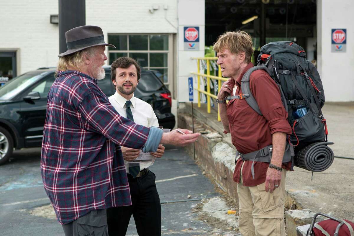 This photo provided by Broad Green Pictures shows, Nick Nolte, from left, as Stephen Katz, Rowan Bousaid as the Car Rental Agent and Robert Redford as Bill Bryson hiding from fellow hiker, Kristen Schaal as Mary Ellen, along the Appalachian Trail in the film, "A Walk in the Woods." Redford co-stars with Nolte and Emma Thompson in the movie which releases in U.S. theaters on Sept. 2, 2015. (Frank Masi, SMPSP/Broad Green Pictures via AP)