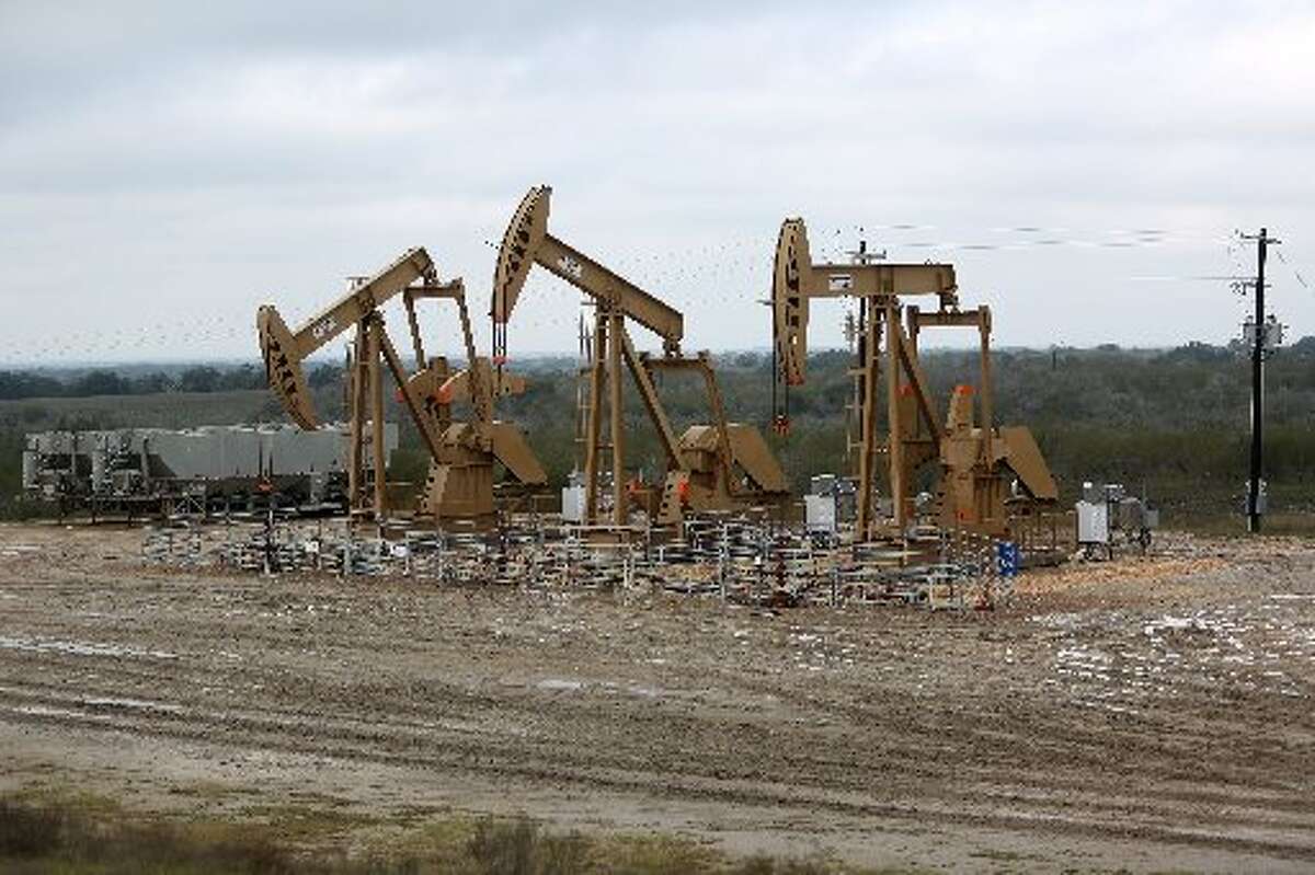 The brushy South Texas plain forms a backdrop for pumpjacks working in the Eagle Ford Shale. (Gary Coronado / Houston Chronicle)