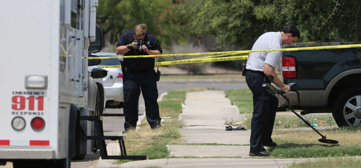 In this photo taken Friday, Aug. 28, 2015, the Bexar County Sheriff's Department investigates the scene where deputies shot a man as they responded to a domestic disturbance call in Northwest Bexar County, Texas, near San Antonio. Gilbert Flores, 41, who was taken to a hospital, died shortly after the shooting Friday, the Bexar County Sheriff's Office said in a statement Monday, Aug. 31, 2015. Video obtained by KSAT-TV, that was taken by a bystander, appears to show Flores standing still with his arms raised just before two shots are heard. The deputies are on administrative leave. (John Davenport/The San Antonio Express-News via AP) RUMBO DE SAN ANTONIO OUT; NO SALES; MANDATORY CREDIT MBO