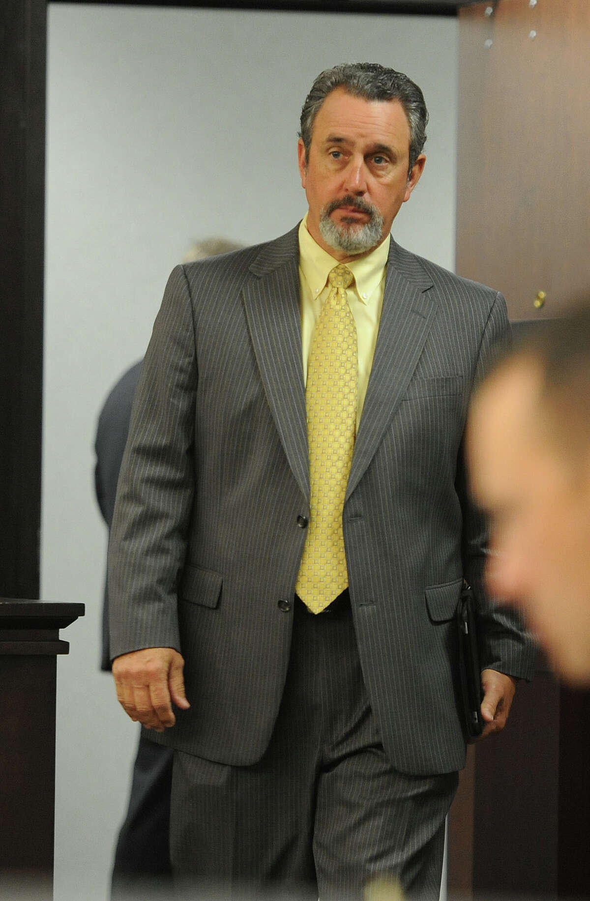 Jefferson County Sheriff Mitch Woods enters the courtroom just before the second day of trial begins in a Galveston County courtroom on Tuesday. Granger stands trial for the 2012 shooting of Minnie Ray Sebolt at the Jefferson County Courthouse. Photo taken Tuesday, April 23, 2013 Guiseppe Barranco/The Enterprise