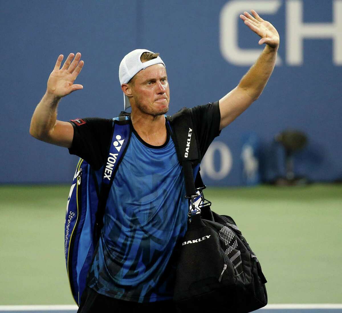 Lleyton Hewitt, of Australia, bids farewell to the crowd after losing to countryman Bernard Tomic, 6-3, 6-2, 3-6, 5-7, 7-5, during the second round of the U.S. Open tennis tournament in New York, Thursday, Sept. 3, 2015. (AP Photo/Kathy Willens)