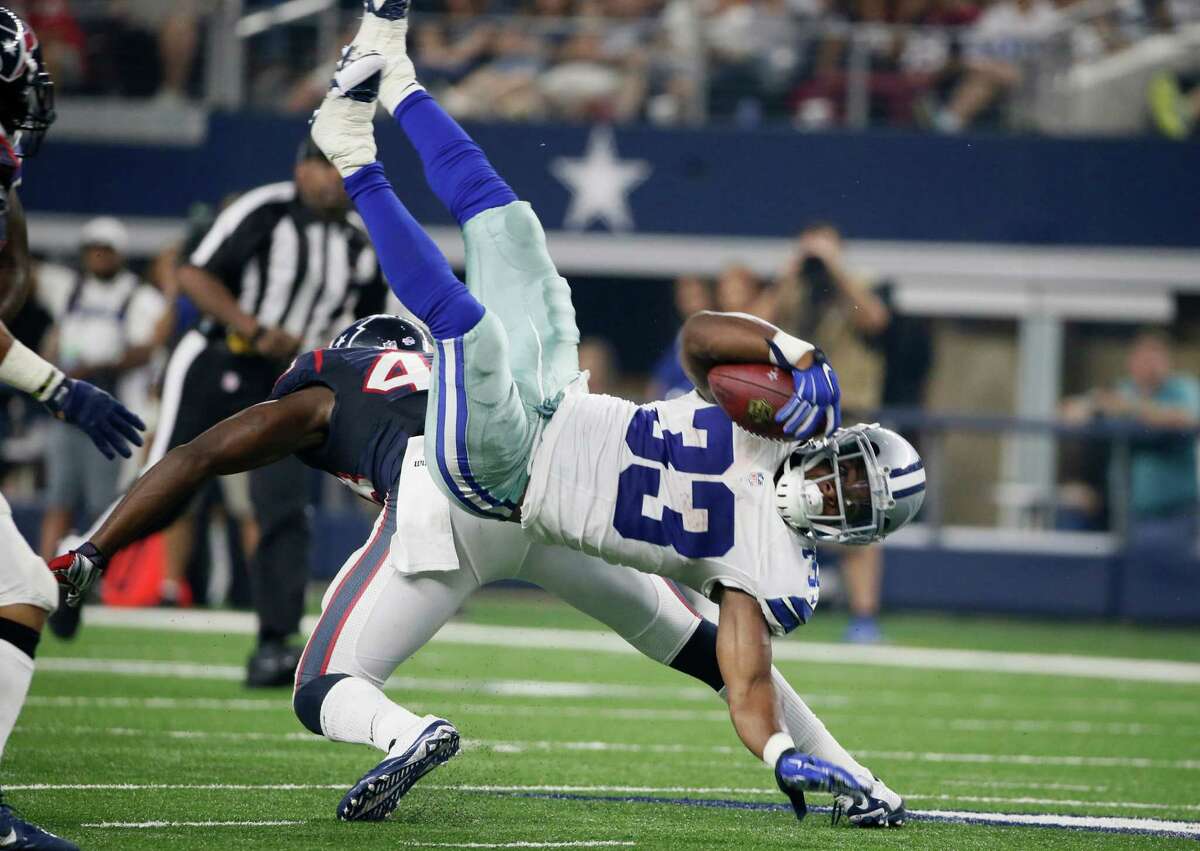 Dallas Cowboys running back Ben Malena (33) is tackled by Houston Texans defensive back Corey Moore (43) during the second half of a preseason NFL football game Thursday, Sept. 3, 2015, in Arlington, Texas. (AP Photo/Tony Gutierrez)