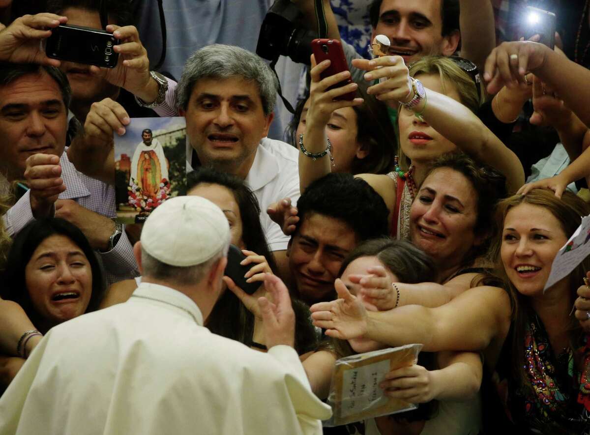 Pope Francis is cheered by faithful as he arrives in the Paul VI hall at the Vatican, Wednesday, Aug. 5, 2015. (AP Photo/Gregorio Borgia)