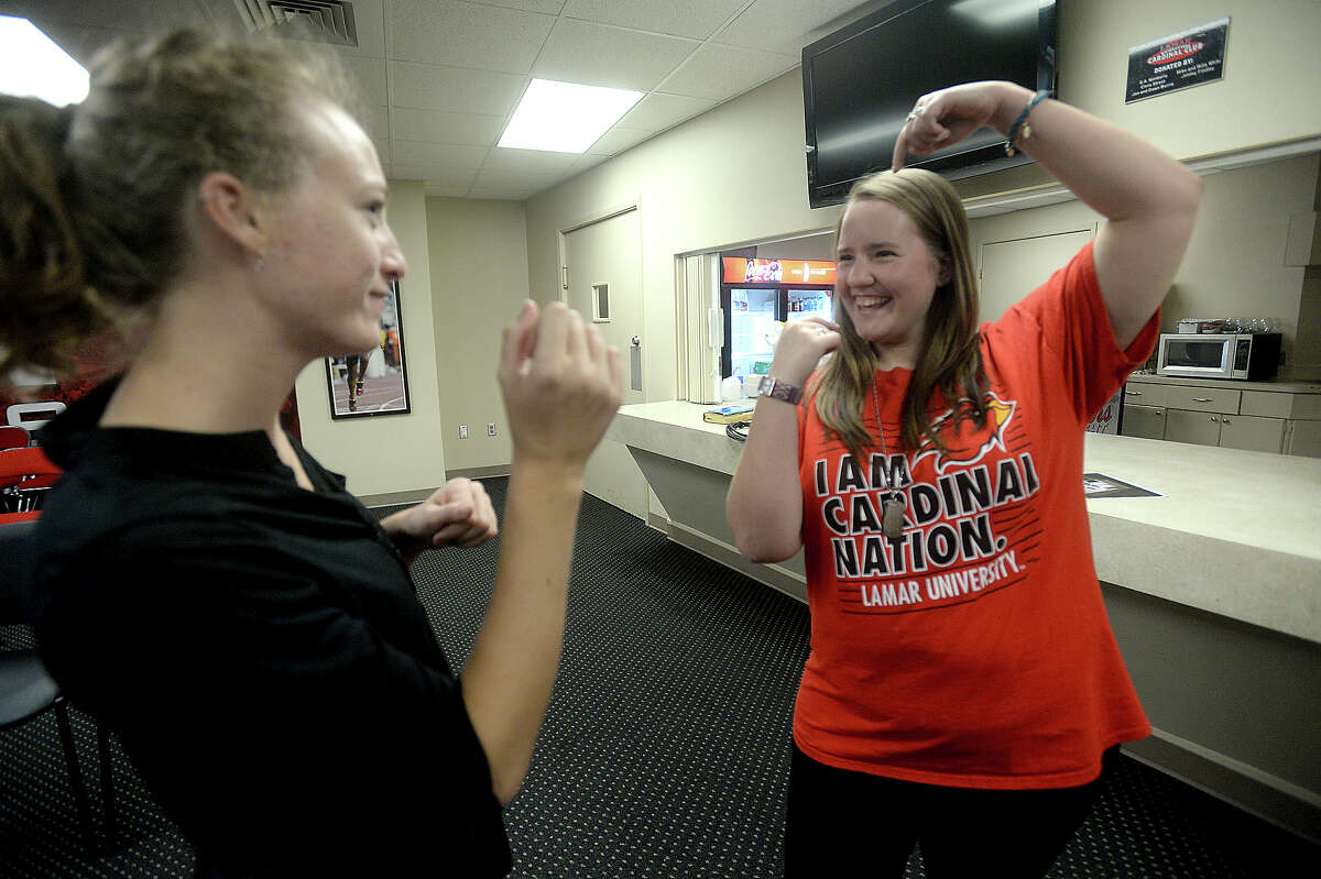 Allie Hayes (right), a junior at Lamar University majoring in the teaching track of American Sign Language (ASL), talks with Jessica Romine, who acts as a student interpreter at Beaumont's Campus Church Wednesday services. The weekly group meets at the Montagne Center, offering worship time for those who are hearing - impaired as well as others studying ASL. Allie was born profoundly deaf, and received her first cochlear implant when she was 20-months-old. At 13, she chose to get a second implant, and though it significantly aids in her ability to hear, says there are still challenges. Photo taken Wednesday, September 2, 2015 Photo by Kim Brent